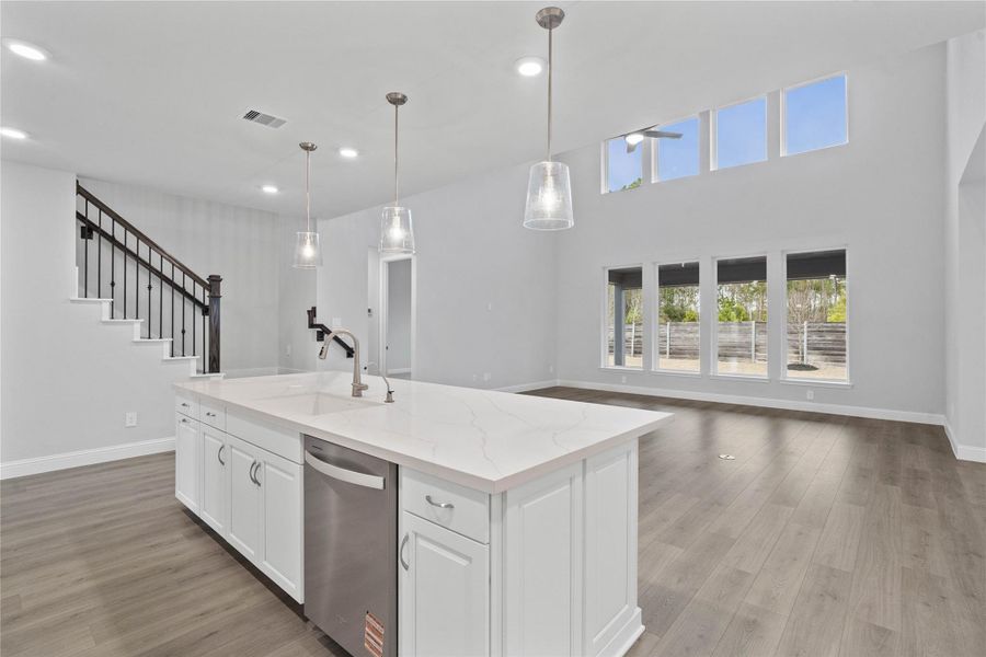 Enjoy commanding sightlines across the oversized kitchen island into the family room and this open-concept layout. Enjoy commanding sightlines across the oversized kitchen island into the family room and this open-concept layout.