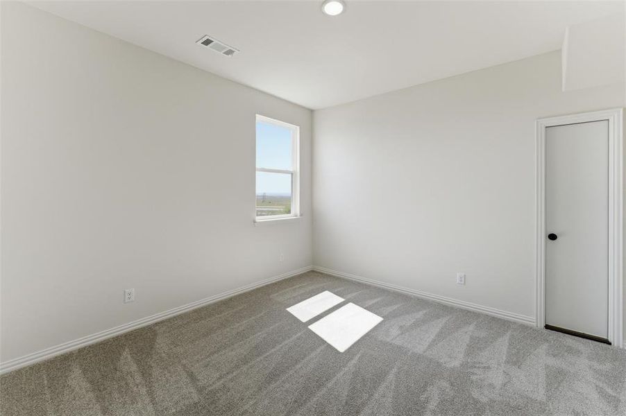 Empty room featuring carpet floors and baseboards Empty room featuring carpet floors and baseboards