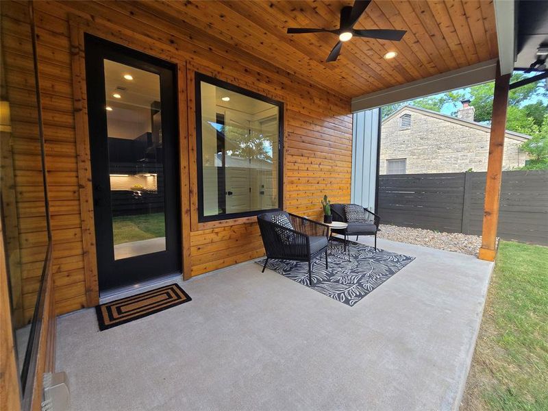 Rear covered porch with a fan to help blow away any summer bugs/insects when you enjoy sitting out.