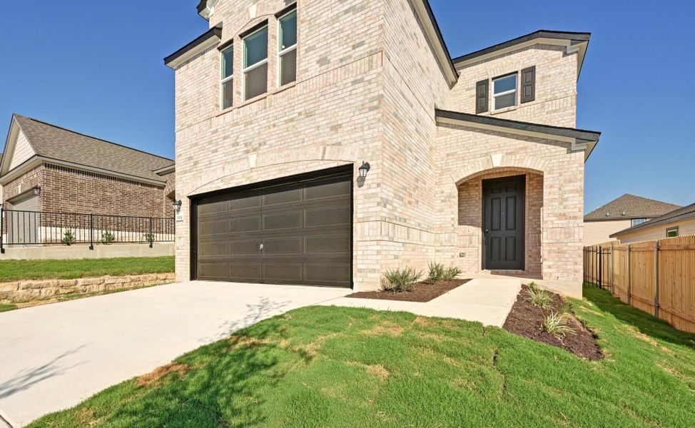 Front exterior of a new home in Creekside at Estancia, Austin, TX, highlighting curb appeal (Image 19).