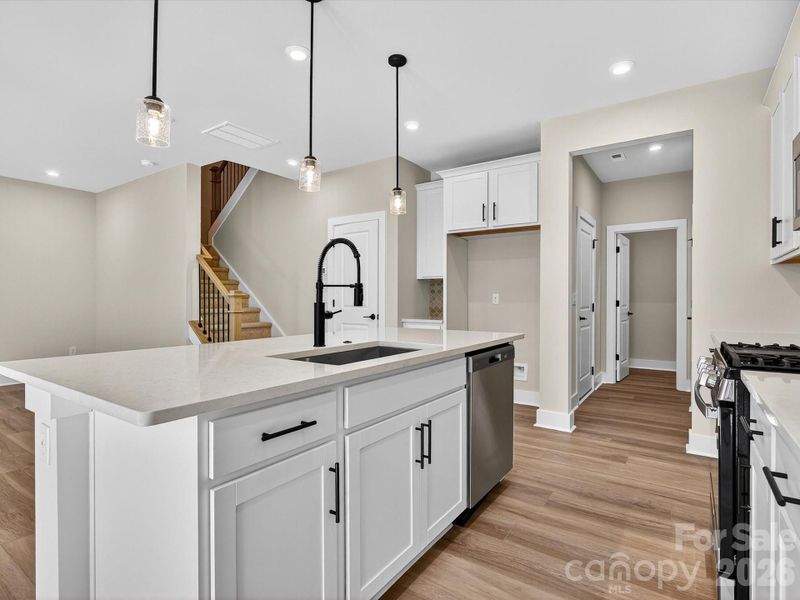 Chef Inspired Kitchen with White Cabinets and Black Hardware Elements