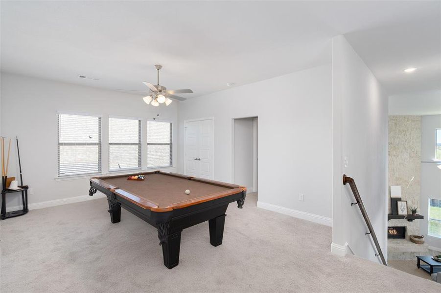 Rec room featuring light carpet, pool table, and plenty of natural light