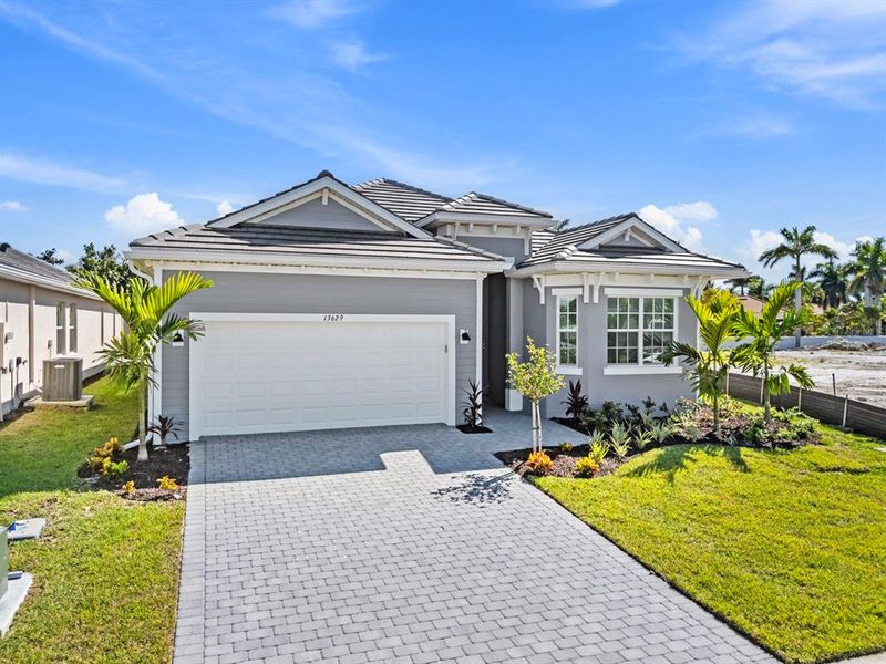 Front exterior of a new home in Sandy Key, Fort Myers, FL, highlighting curb appeal (Image 2).