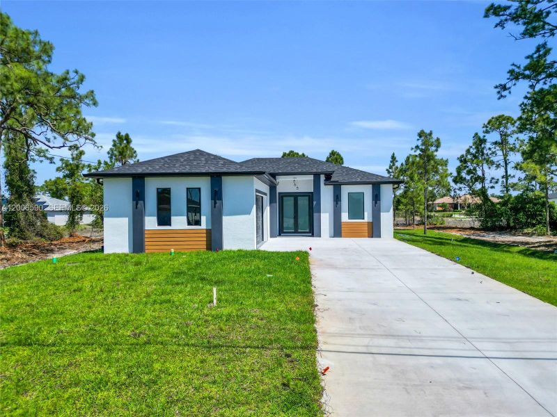 Front exterior of a new home in , Lehigh Acres, FL, highlighting curb appeal (Image 28).