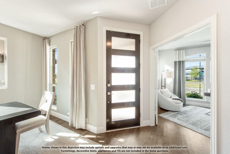 Entryway with dark front door featuring glass panels, hardwood floors, and view into living room Entryway with dark front door featuring glass panels, hardwood floors, and view into living room