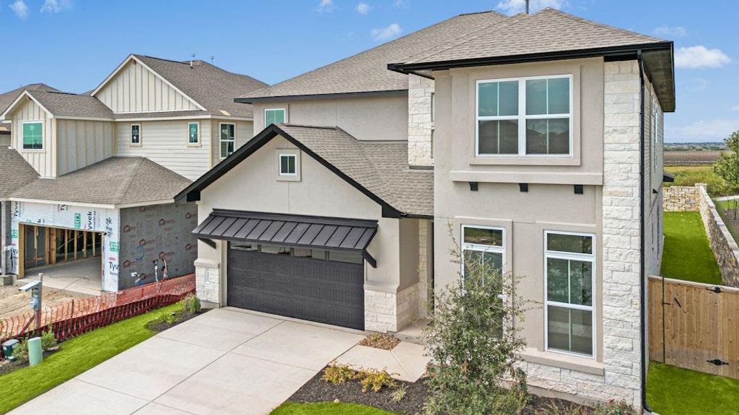 Front exterior of a new home in University Heights, Round Rock, TX, highlighting curb appeal (Image 19).
