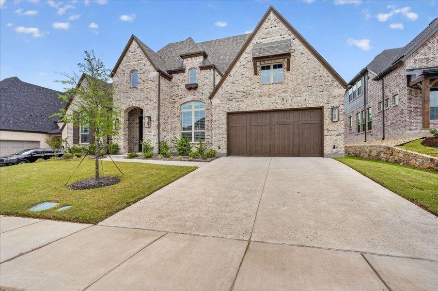 Front exterior of a new home in Saddle Star Estates, Rockwall, TX, highlighting curb appeal (Image 26).