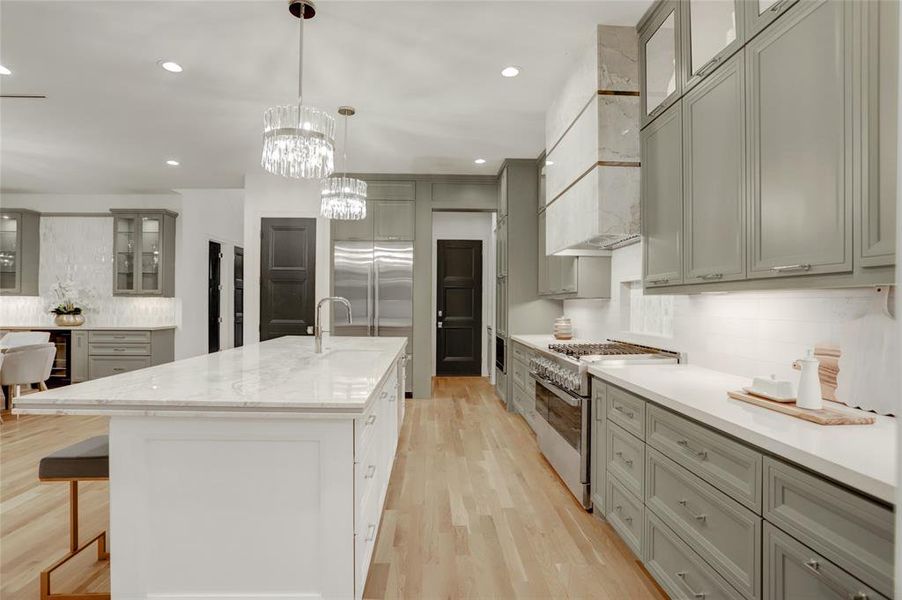 View of kitchen showing access to mudroom and garage, walk-in pantry, the French door, refrigerator, and incredible storage in useful drawers and pullouts