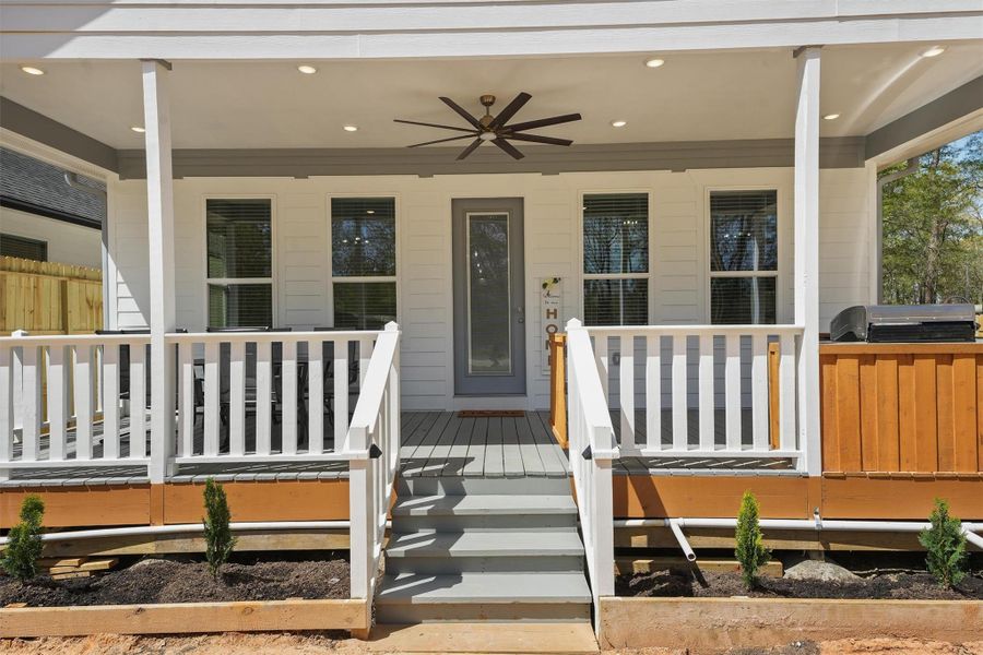 This inviting porch features a modern ceiling fan, recessed lighting, and a welcoming entrance. This inviting porch features a modern ceiling fan, recessed lighting, and a welcoming entrance.