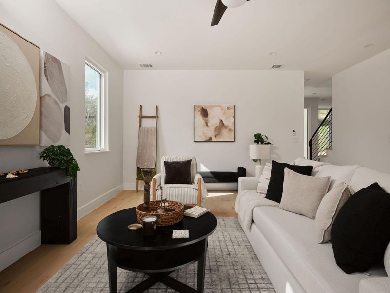 Living area featuring wood finished floors and ceiling fan Living area featuring wood finished floors and ceiling fan