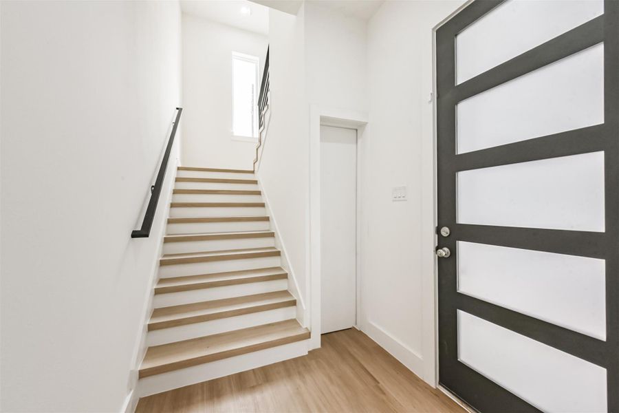 Upon entering the home you can take the stairs or go into the first floor bedroom. The hidden door next to the stairs leads to an extensive under staircase storage space with shelving.