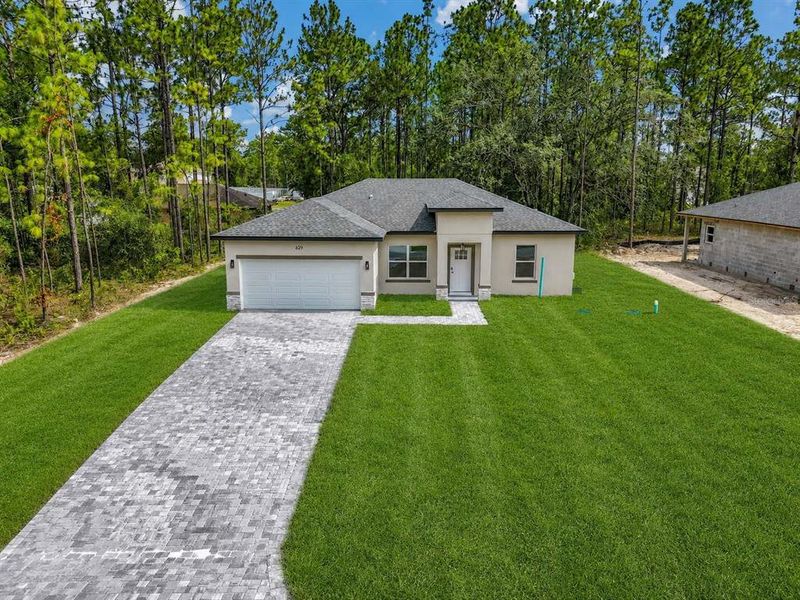 Front exterior of a new home in , Citrus Springs, FL, highlighting curb appeal (Image 18). Front exterior of a new home in , Citrus Springs, FL, highlighting curb appeal (Image 18).