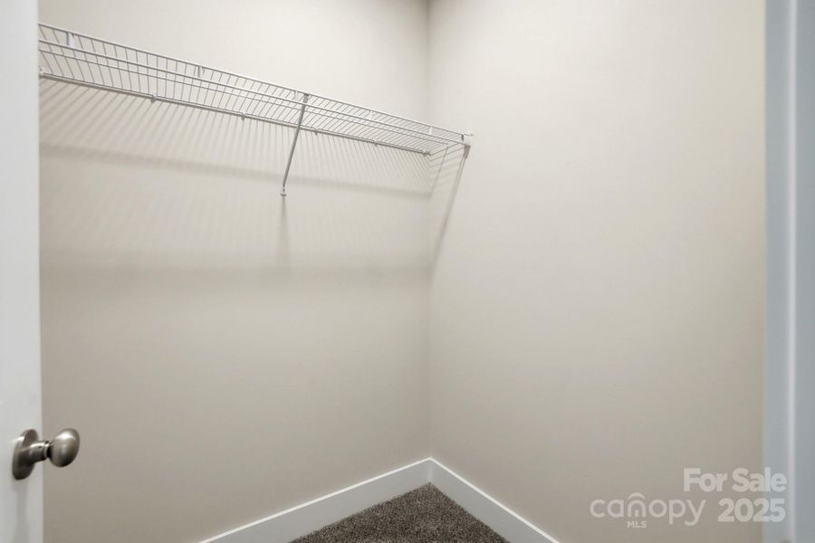 Primary Bedroom's walk-in closet Primary Bedroom's walk-in closet