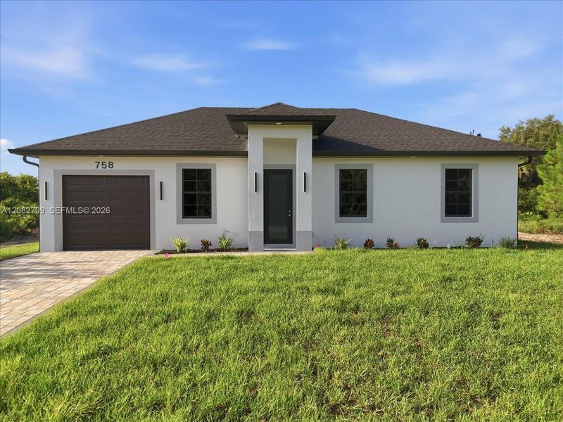 Front exterior of a new home in , Lehigh Acres, FL, highlighting curb appeal (Image 24).