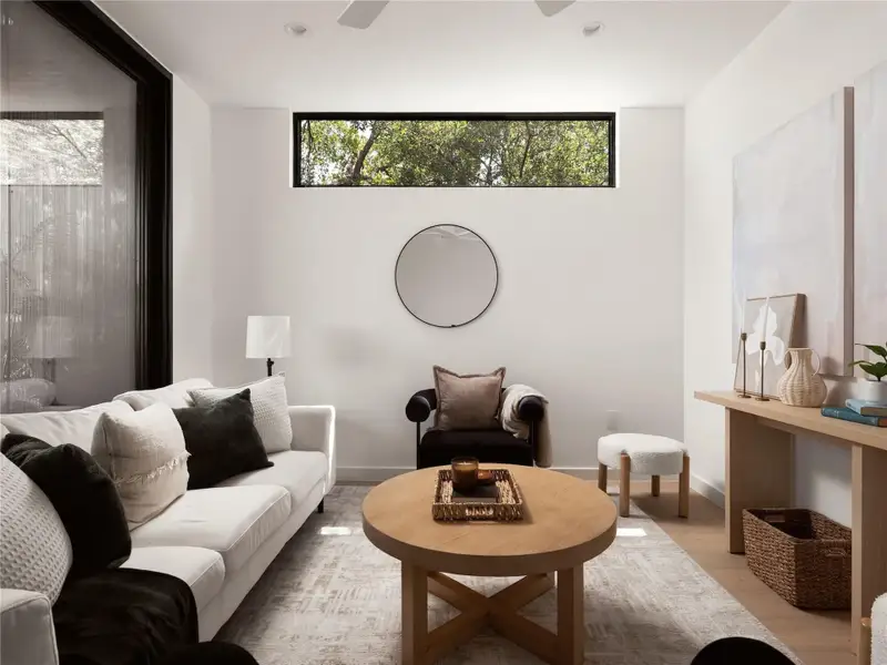 A well-lit secondary living area faces the private terrace and offers comfort with large windows and durable hardwood flooring. A well-lit secondary living area faces the private terrace and offers comfort with large windows and durable hardwood flooring.