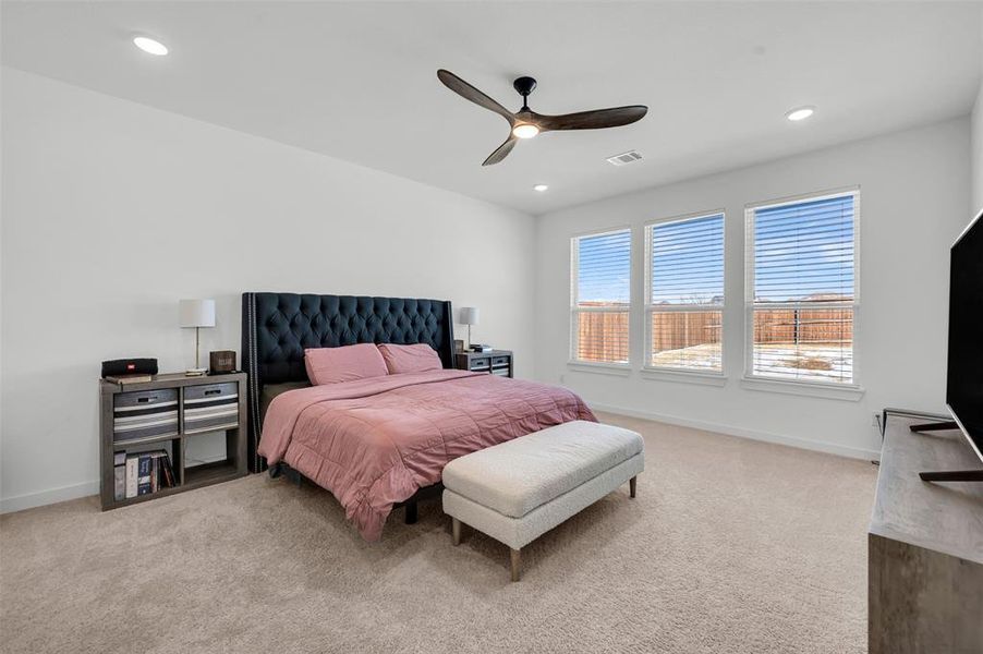 Bedroom with light colored carpet and ceiling fan