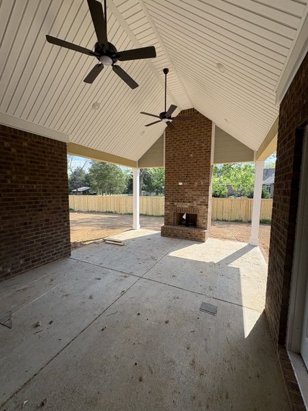 Jumbo Patio with cathedral ceiling and elaborate bricked fireplace center piece.