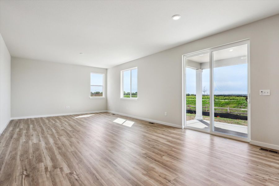 A room with a wood floor and windows.