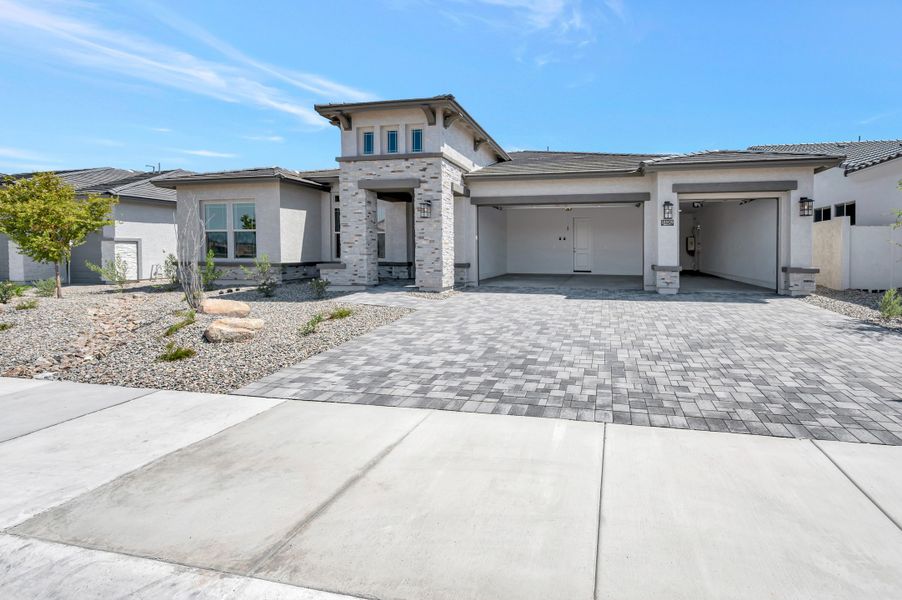 Front exterior of a new home in Sentiero at Windrose, Waddell, AZ, highlighting curb appeal (Image 2). Front exterior of a new home in Sentiero at Windrose, Waddell, AZ, highlighting curb appeal (Image 2).