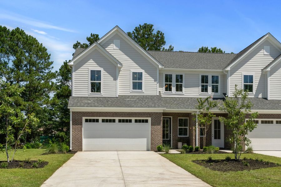 Front exterior of a new home in Long Bay Golf Club, Longs, SC, highlighting curb appeal (Image 2). Front exterior of a new home in Long Bay Golf Club, Longs, SC, highlighting curb appeal (Image 2).