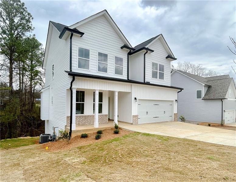 Front exterior of a new home in , Cartersville, GA, highlighting curb appeal (Image 1).