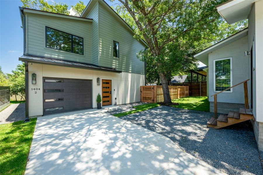 A contemporary exterior showcasing a two-story home with a stylish garage and inviting wooden entry. A contemporary exterior showcasing a two-story home with a stylish garage and inviting wooden entry.