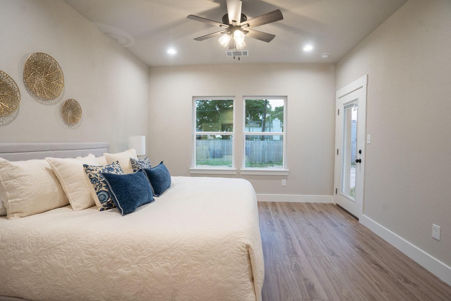 Bedroom with wood finished floors, baseboards, recessed lighting, and ceiling fan