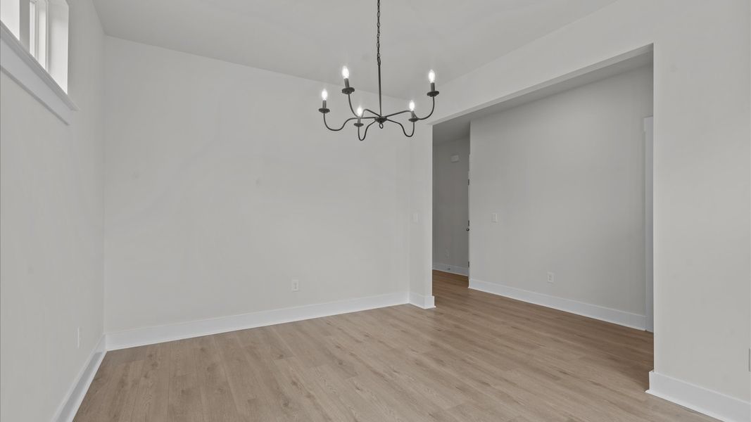 Dining room with large windows in two story townhome at Aspen Ridge by DRB Homes in Lyman, SC Dining room with large windows in two story townhome at Aspen Ridge by DRB Homes in Lyman, SC