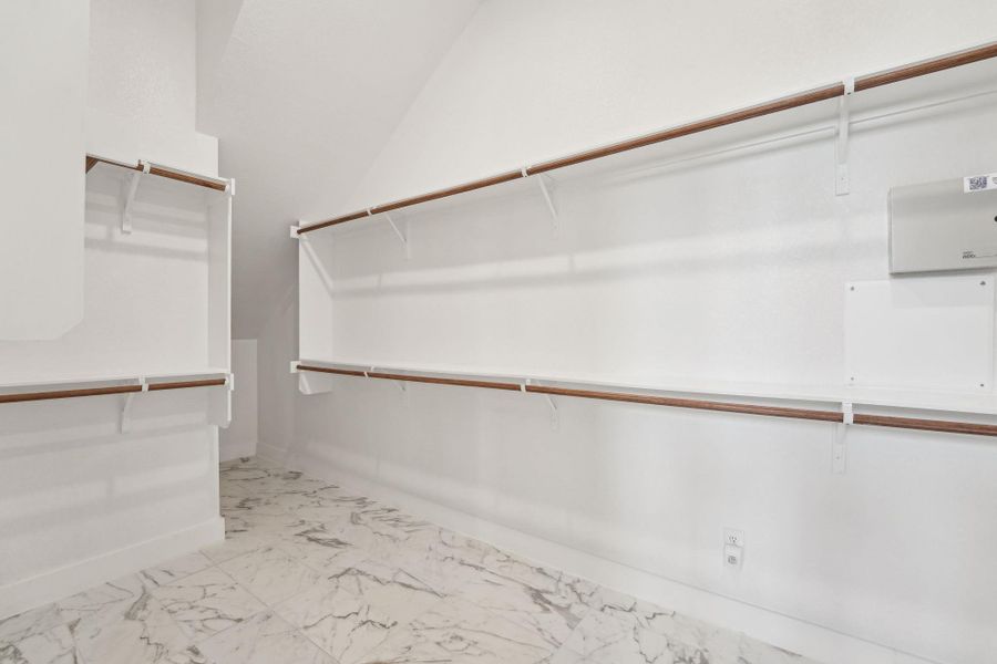 Large primary closet with shelves on back side Large primary closet with shelves on back side