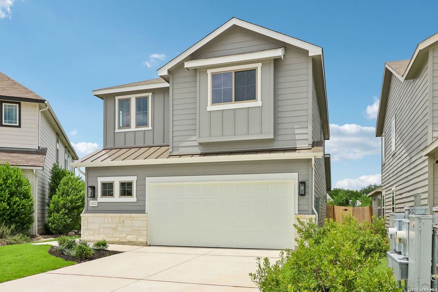 Front exterior of a new home in Casinas at Gruene, New Braunfels, TX, highlighting curb appeal (Image 2). Front exterior of a new home in Casinas at Gruene, New Braunfels, TX, highlighting curb appeal (Image 2).