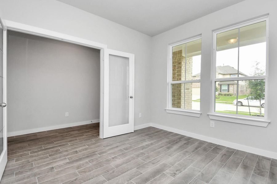 Quietly nestled in front of the home is the sophisticated home office. Featuring elegant flooring, custom paint and large windows. Sample photo, actual color and selections can vary. Quietly nestled in front of the home is the sophisticated home office. Featuring elegant flooring, custom paint and large windows. Sample photo, actual color and selections can vary.