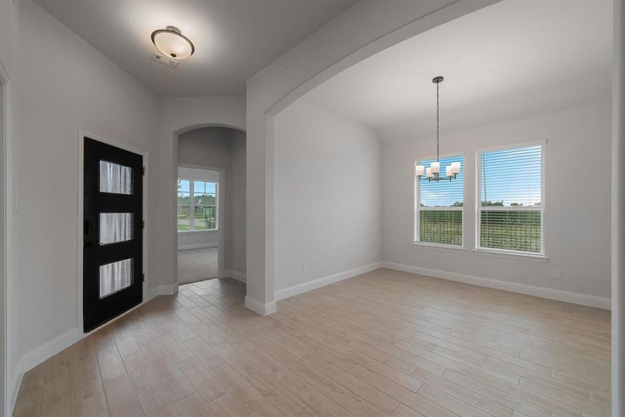 Foyer featuring light hardwood / wood-style flooring and a chandelier