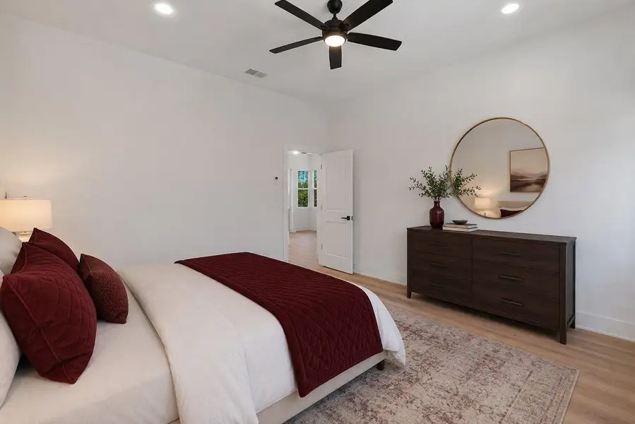 Bright and versatile bedroom featuring high ceilings, modern finishes and stylish wood-look flooring throughout.