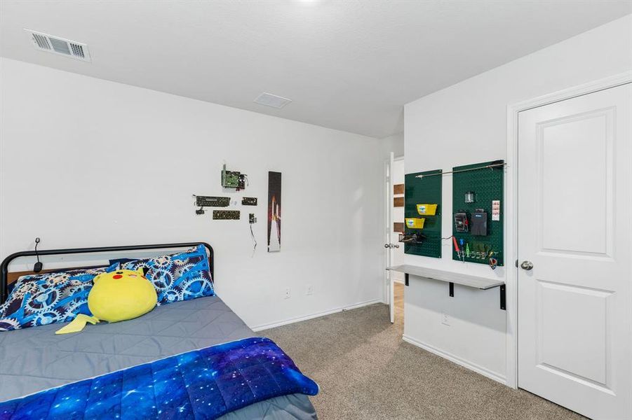 Bedroom featuring light colored carpet and baseboards Bedroom featuring light colored carpet and baseboards