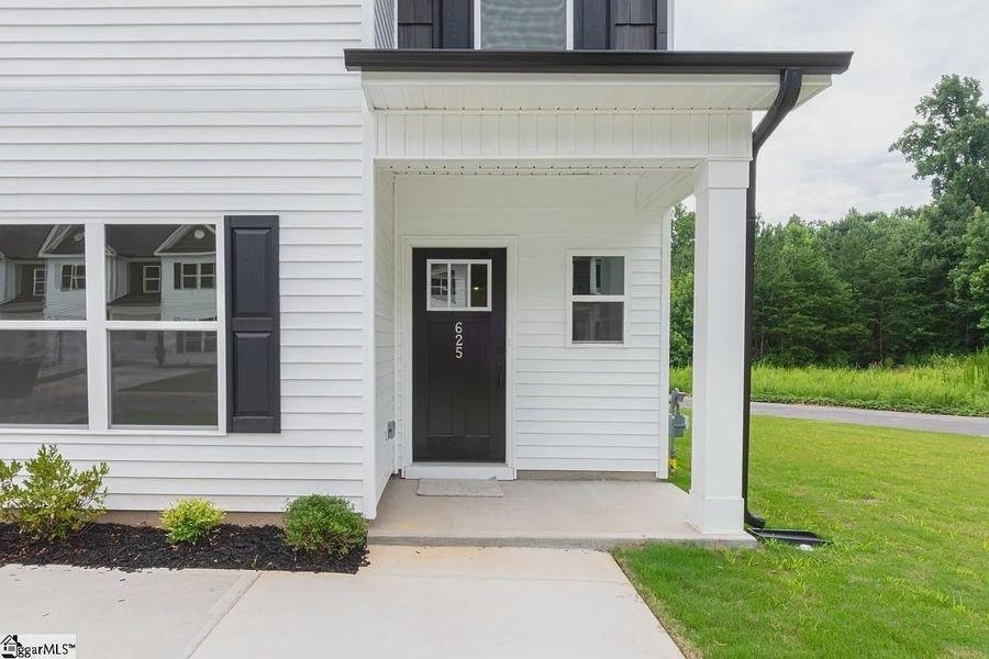 Exterior details and patio area of a home in Parkstone Place Townhomes, Roebuck (Image 3).