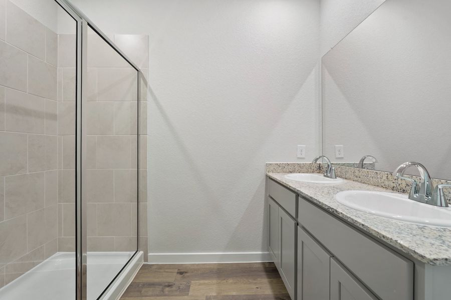 A bathroom with a glass shower. A bathroom with a glass shower.
