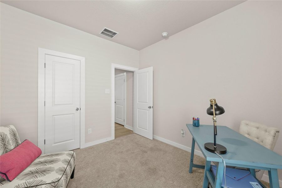 A versatile space features soft carpeting and multiple access points, perfect for a home office or guest room. A versatile space features soft carpeting and multiple access points, perfect for a home office or guest room.