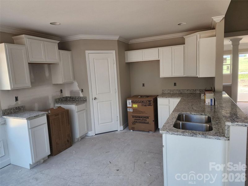 Kitchen w/ Granite Tops, Crown Molding, Walk in Pantry, Decorative Cabinets and SS Appliances