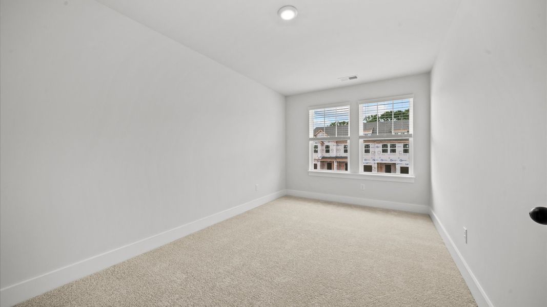 Refined bedroom design with large windows for daylight-filled mornings and peaceful views
