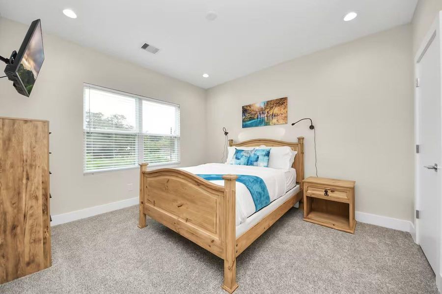 This secondary bedroom offers good natural light and enough floor space for a comfortable bedroom setup, home office, or guest room.