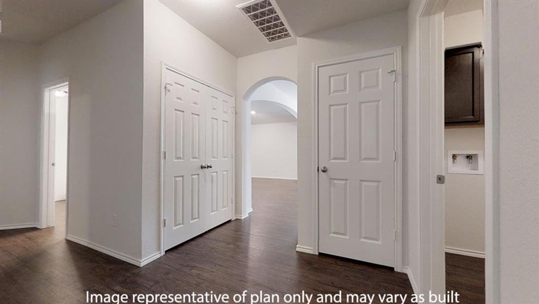 Hall featuring arched walkways and dark wood-style flooring Hall featuring arched walkways and dark wood-style flooring