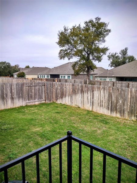 Fenced backyard featuring a residential view