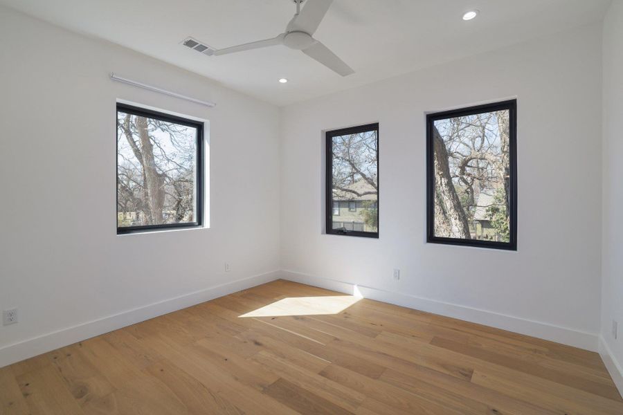 Unfurnished room featuring light wood-type flooring, a ceiling fan, and recessed lighting