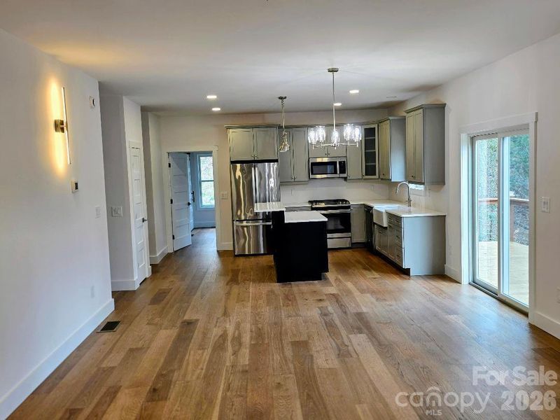 Great room/family room with kitchen and door to the deck