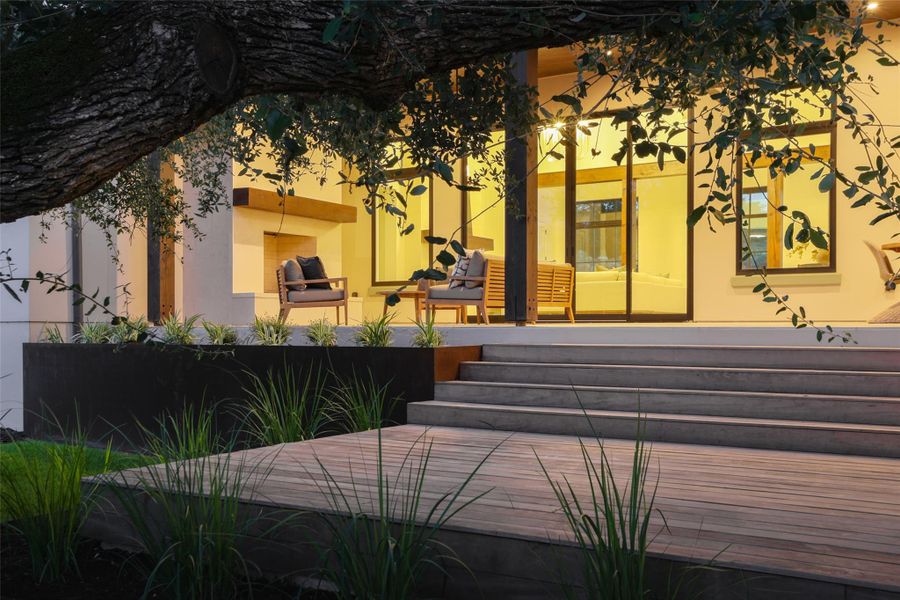Seamless indoor-outdoor flow. This expansive covered back porch serves as a true extension of the home, featuring durable Garapa decking and a wood-plank ceiling. It’s a massive, shaded space designed for lounging poolside while taking in the quiet views of the 1.06-acre greenbelt lot.