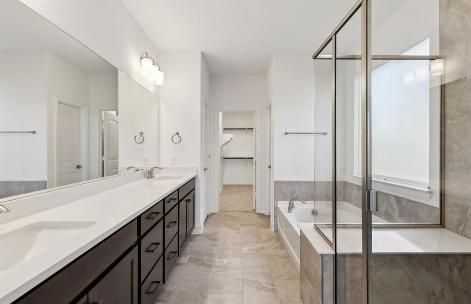 Elegant owner's bathroom with dual vanity *real home pictured