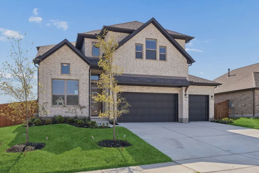 Front exterior of a new home in Las Lomas, Forney, TX, highlighting curb appeal (Image 2). Front exterior of a new home in Las Lomas, Forney, TX, highlighting curb appeal (Image 2).