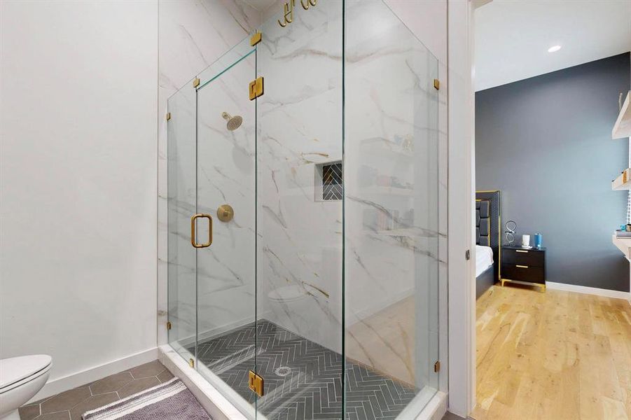 Bathroom with a marble finish shower and connected bathroom Bathroom with a marble finish shower and connected bathroom