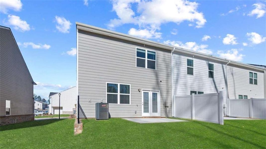 Exterior details and patio area of a home in Inverness at Sugarloaf, Lawrenceville (Image 3).