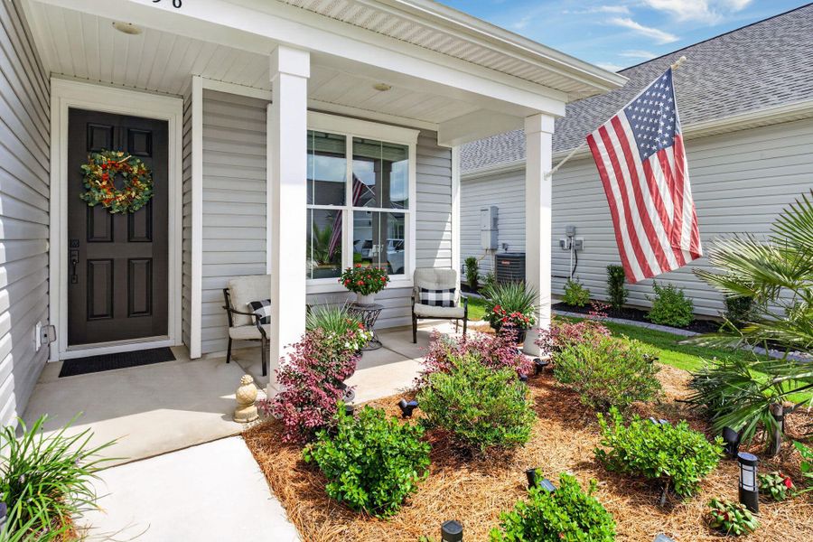 Exterior details and patio area of a home in K. Hovnanian's® Four Seasons at Lakes of Cane Bay, Summerville (Image 29).